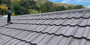  A tiled roof that has recently been refurbished with a new roof coating, providing much more effective protection from the Scottish weather